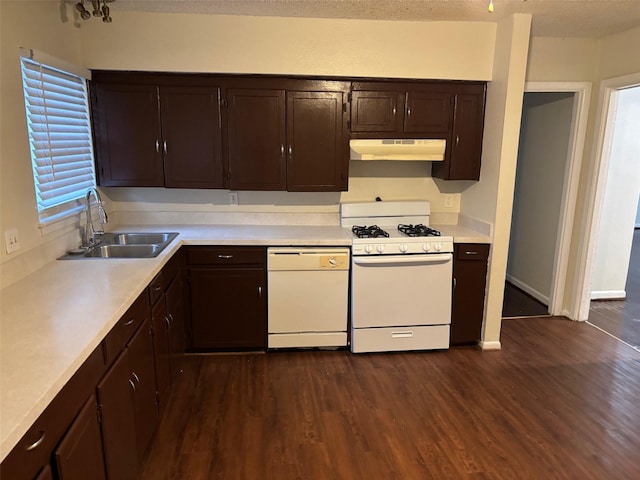 437 Browning Dr, Arlington, TX 76010 - kitchen featuring white appliances, under cabinet range hood, a sink, dark wood-type flooring, and a textured ceiling