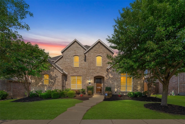 8803 Kelvington Dr, Frisco, TX 75035 - french country style house featuring brick siding and a lawn