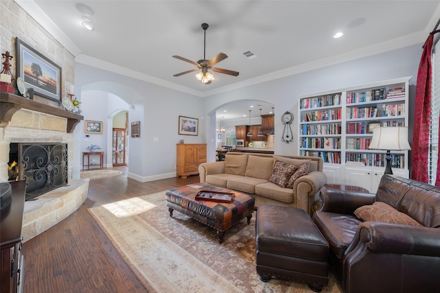 8803 Kelvington Dr, Frisco, TX 75035 - living area with arched walkways, ceiling fan, wood finished floors, crown molding, and baseboards