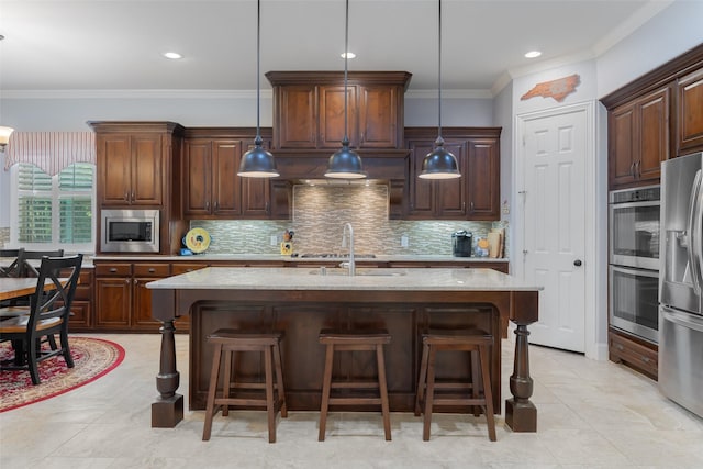 8803 Kelvington Dr, Frisco, TX 75035 - kitchen featuring stainless steel appliances, light stone countertops, a sink, a kitchen breakfast bar, and ornamental molding