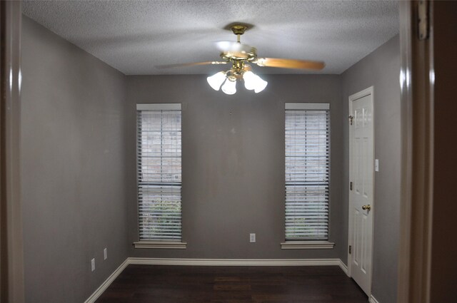 1720 Red Oak Cir, Sulphur Springs, TX 75482 - unfurnished room with a textured ceiling, dark wood-style flooring, baseboards, and a ceiling fan