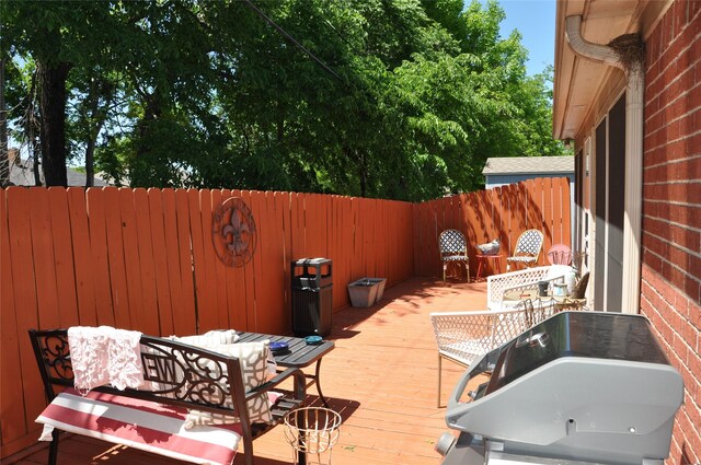 1720 Red Oak Cir, Sulphur Springs, TX 75482 - wooden terrace featuring a fenced backyard, outdoor dining area, and outdoor lounge area