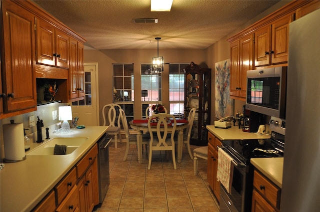 1720 Red Oak Cir, Sulphur Springs, TX 75482 - kitchen with appliances with stainless steel finishes, a sink, light countertops, brown cabinets, and light tile patterned floors