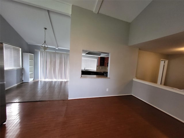 1005 Via Balboa, Mesquite, TX 75150 - unfurnished living room with high vaulted ceiling, wood finished floors, baseboards, and beamed ceiling