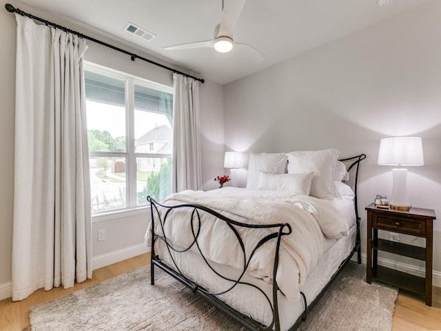 4837 Cumberland Cir, Carrollton, TX 75010 - bedroom featuring light wood finished floors, baseboards, and a ceiling fan
