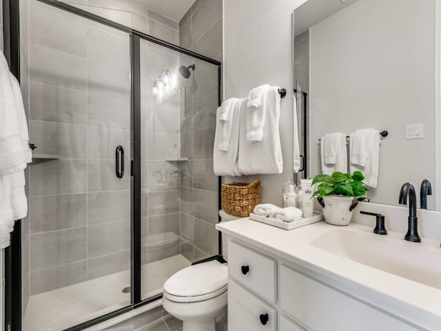 4837 Cumberland Cir, Carrollton, TX 75010 - bathroom featuring vanity, a shower stall, and toilet