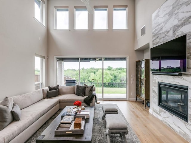 4837 Cumberland Cir, Carrollton, TX 75010 - living room with a high ceiling, wood finished floors, and a premium fireplace