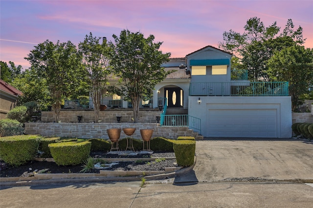 3405 Waterview Trl, Rockwall, TX 75087 - view of front of home featuring driveway, a tiled roof, stucco siding, and an attached garage