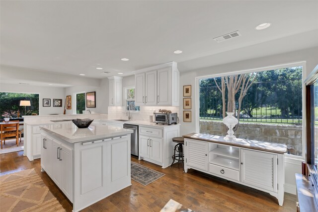 3405 Waterview Trl, Rockwall, TX 75087 - kitchen featuring stainless steel dishwasher, a sink, white cabinetry, healthy amount of natural light, and recessed lighting