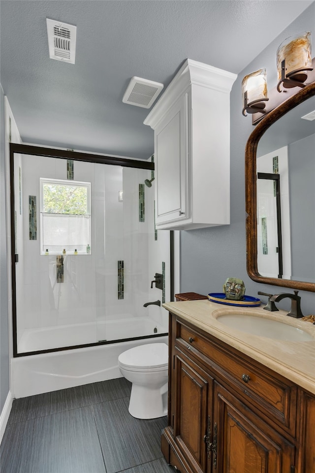 3405 Waterview Trl, Rockwall, TX 75087 - bathroom featuring toilet, vanity, enclosed tub / shower combo, and a textured ceiling