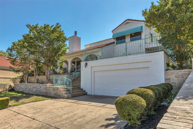 3405 Waterview Trl, Rockwall, TX 75087 - view of front of property with driveway, stucco siding, a chimney, and a balcony