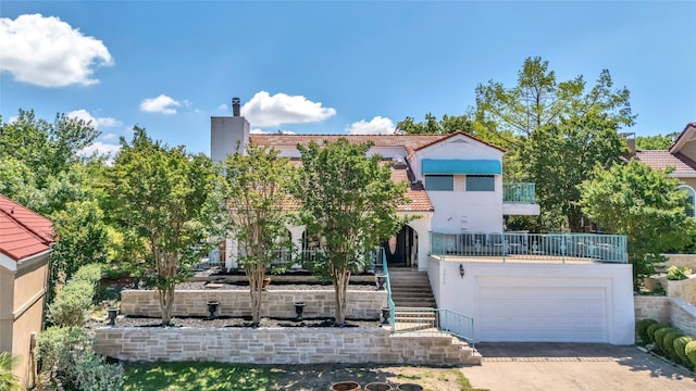 3405 Waterview Trl, Rockwall, TX 75087 - view of front of house with stairway, a tile roof, driveway, stucco siding, and a chimney