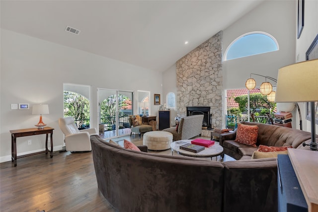 3405 Waterview Trl, Rockwall, TX 75087 - living room with high vaulted ceiling, wood finished floors, a stone fireplace, and baseboards