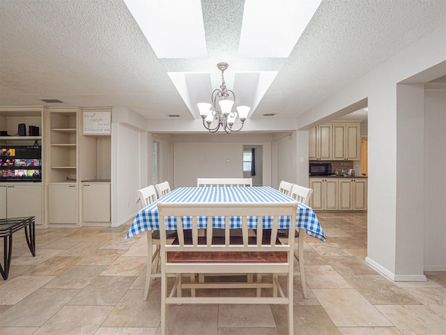 4029 Aragon Dr, Fort Worth, TX 76133 - dining room with a chandelier, a textured ceiling, a skylight, and stone tile floors