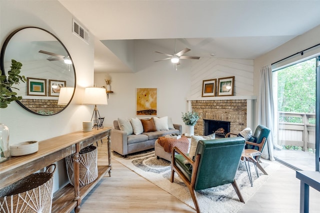 7640 W Greenway Blvd Unit 5P, Dallas, TX 75209 - living room with ceiling fan, light wood finished floors, a brick fireplace, and vaulted ceiling