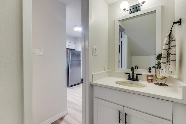 7640 W Greenway Blvd Unit 5P, Dallas, TX 75209 - bathroom featuring wood finished floors and vanity