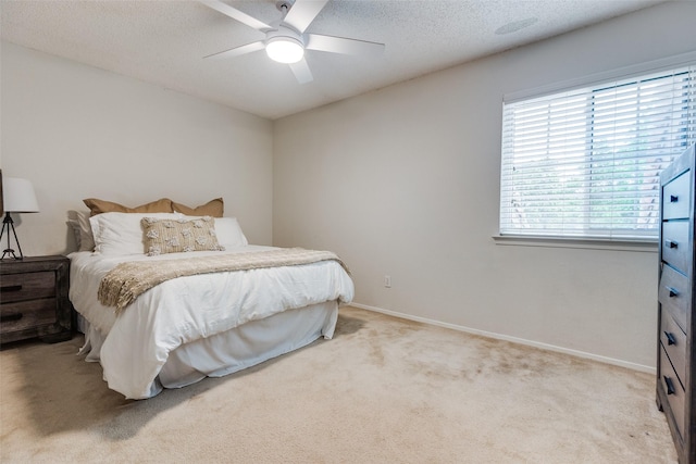 7640 W Greenway Blvd Unit 5P, Dallas, TX 75209 - bedroom featuring light carpet, a textured ceiling, a ceiling fan, and baseboards
