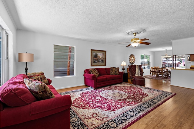 210 Harbor Dr, Gun Barrel City, TX 75156 - living room with ceiling fan, a textured ceiling, wood finished floors, and a chandelier
