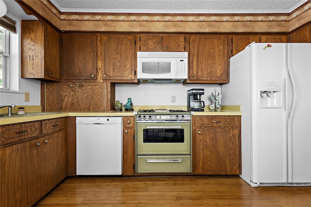 210 Harbor Dr, Gun Barrel City, TX 75156 - kitchen featuring white appliances, light countertops, and brown cabinets