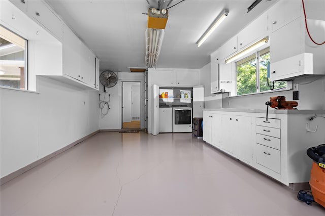 210 Harbor Dr, Gun Barrel City, TX 75156 - kitchen featuring washer and clothes dryer, white cabinets, finished concrete flooring, and light countertops