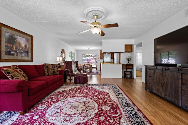 210 Harbor Dr, Gun Barrel City, TX 75156 - living area with wood finished floors, ceiling fan, a chandelier, and a textured ceiling