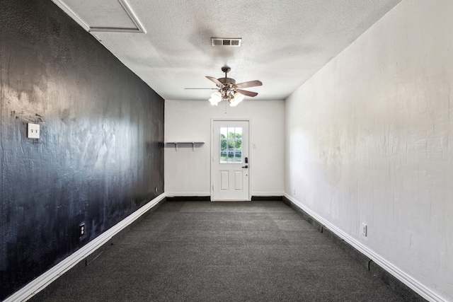 3843 Bernal Dr, Dallas, TX 75212 - spare room with a textured ceiling, dark carpet, ceiling fan, baseboards, and attic access
