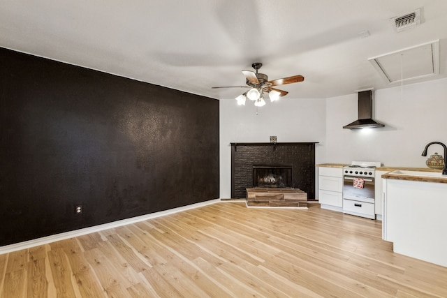 3843 Bernal Dr, Dallas, TX 75212 - unfurnished living room featuring attic access, ceiling fan, light wood finished floors, and a sink