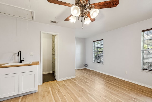 3843 Bernal Dr, Dallas, TX 75212 - unfurnished bedroom with attic access, a sink, light wood-type flooring, and baseboards