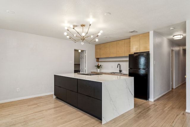 3843 Bernal Dr, Dallas, TX 75212 - kitchen with freestanding refrigerator, a sink, modern cabinets, a center island, and light wood finished floors