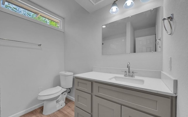 1413 Shelburne St, Waco, TX 76711 - bathroom featuring toilet, wood finished floors, baseboards, and vanity