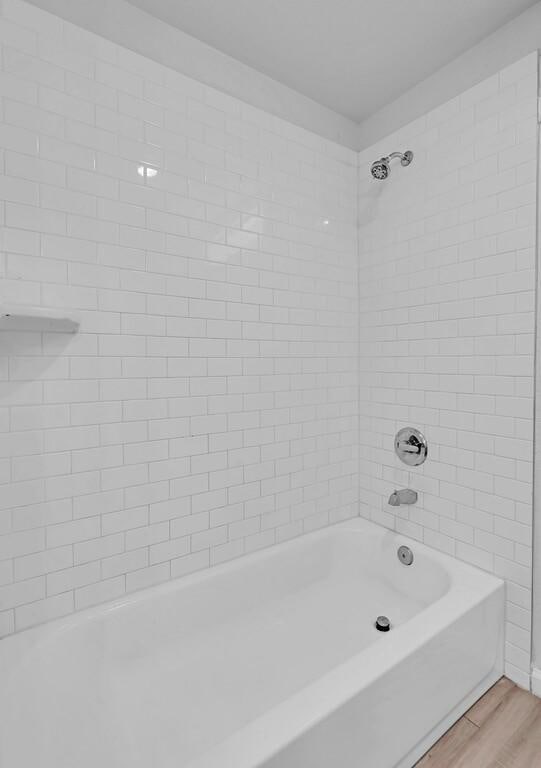 1413 Shelburne St, Waco, TX 76711 - full bathroom with wood finished floors and  shower combination