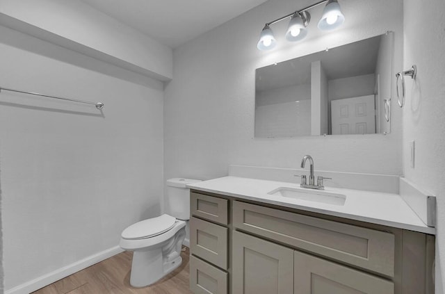 1413 Shelburne St, Waco, TX 76711 - bathroom with wood finished floors, toilet, vanity, and baseboards