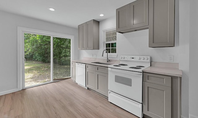 1413 Shelburne St, Waco, TX 76711 - kitchen featuring white appliances, gray cabinetry, a sink, light countertops, and light wood-style floors
