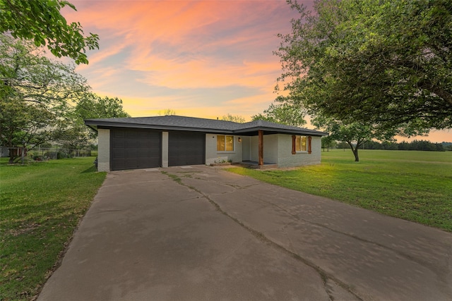 527 Dison Dr, Waco, TX 76706 - view of front facade with an attached garage, a yard, driveway, and brick siding