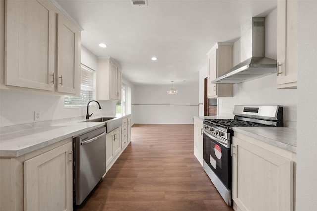527 Dison Dr, Waco, TX 76706 - kitchen with appliances with stainless steel finishes, wall chimney range hood, dark wood-style flooring, recessed lighting, and a sink