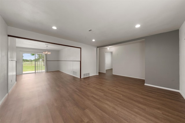 527 Dison Dr, Waco, TX 76706 - unfurnished room with wood finished floors, a chandelier, baseboards, and recessed lighting