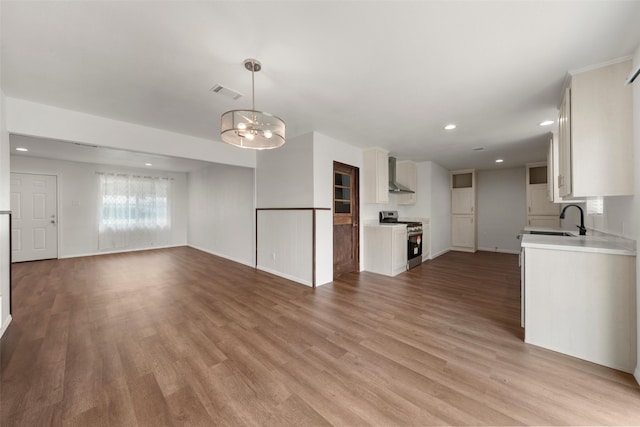 527 Dison Dr, Waco, TX 76706 - unfurnished living room with a sink, recessed lighting, light wood finished floors, a chandelier, and baseboards