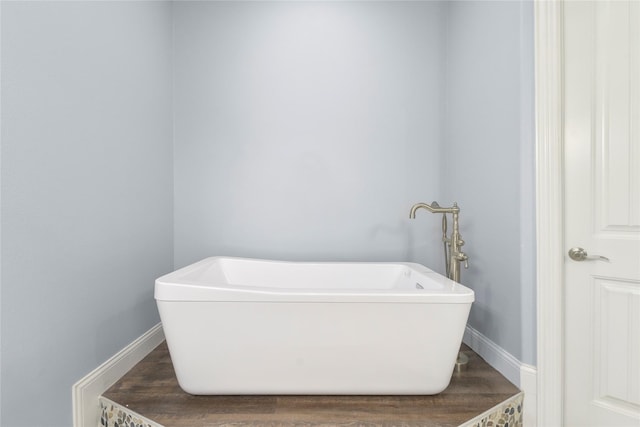 12198 Briargove Ln, Talty, TX 75126 - bathroom with a freestanding tub, baseboards, and wood finished floors