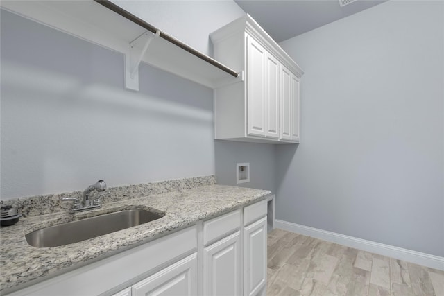 12198 Briargove Ln, Talty, TX 75126 - washroom featuring washer hookup, light wood-style floors, cabinet space, and baseboards