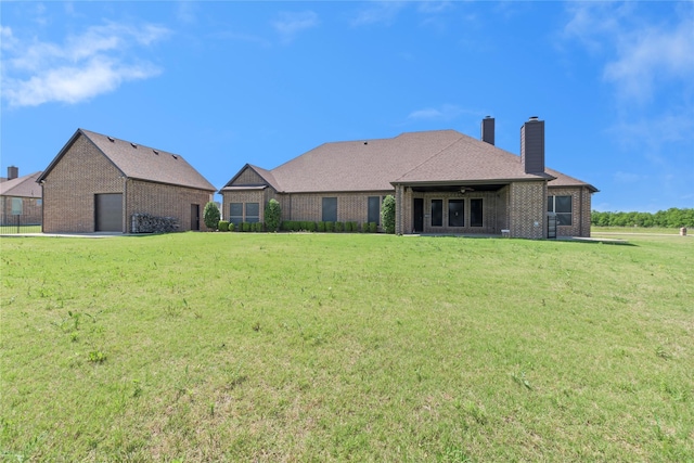 12198 Briargove Ln, Talty, TX 75126 - rear view of property featuring brick siding, a chimney, a yard, and a garage