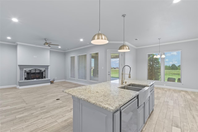 12198 Briargove Ln, Talty, TX 75126 - kitchen with a sink, ceiling fan, light wood finished floors, baseboards, and ornamental molding