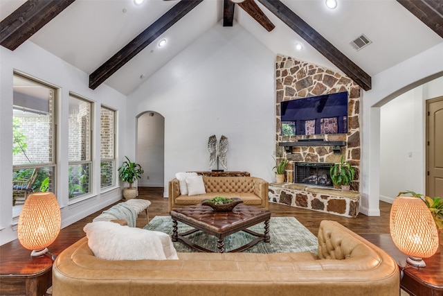 1716 Caman Park Dr, Lucas, TX 75002 - living room featuring arched walkways, beamed ceiling, baseboards, wood finished floors, and a stone fireplace