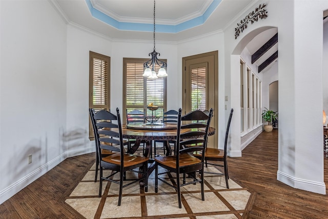 1716 Caman Park Dr, Lucas, TX 75002 - dining room featuring a tray ceiling, arched walkways, wood finished floors, crown molding, and a chandelier