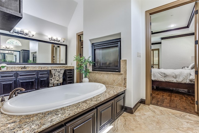 1716 Caman Park Dr, Lucas, TX 75002 - ensuite bathroom with a bath, vanity, vaulted ceiling, and baseboards