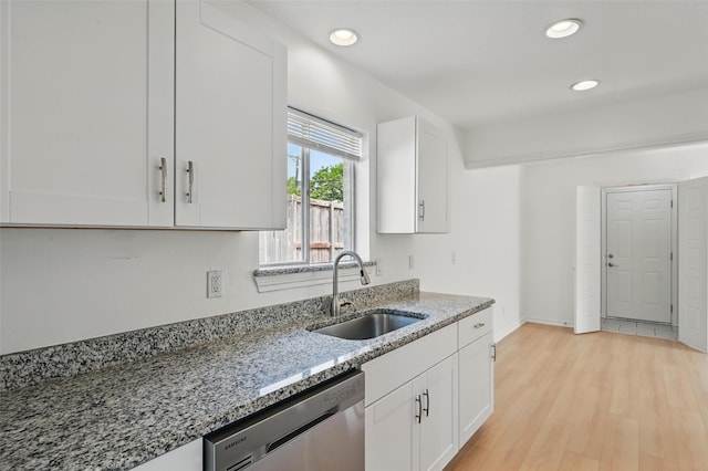 700 Brentwood Ln, Richardson, TX 75080 - kitchen featuring stainless steel dishwasher, a sink, light stone counters, white cabinets, and recessed lighting