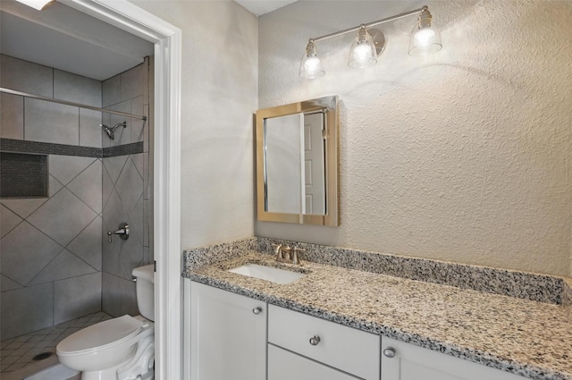 700 Brentwood Ln, Richardson, TX 75080 - full bathroom featuring toilet, a stall shower, vanity, and a textured wall