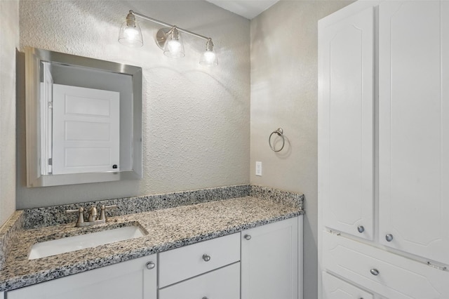 700 Brentwood Ln, Richardson, TX 75080 - bathroom with a textured wall and vanity