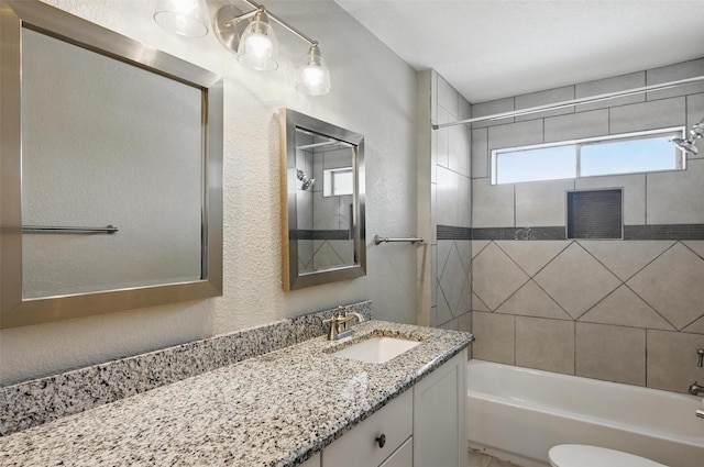 700 Brentwood Ln, Richardson, TX 75080 - full bathroom with a textured wall, vanity, shower / tub combination, and toilet