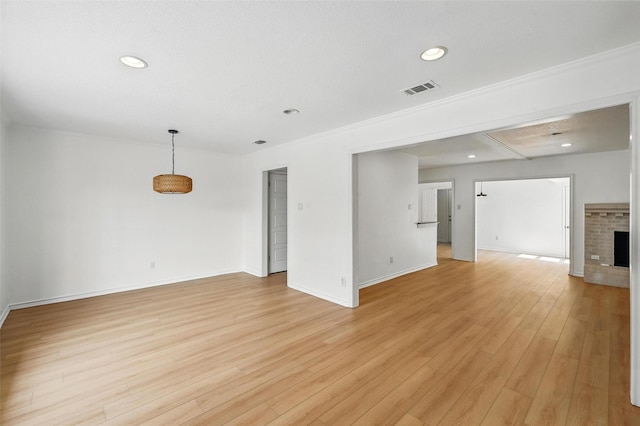 700 Brentwood Ln, Richardson, TX 75080 - unfurnished living room featuring light wood-style flooring, baseboards, recessed lighting, a fireplace, and ornamental molding