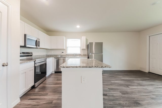 155 Westview Dr, Gun Barrel City, TX 75156 - kitchen with stainless steel appliances, a kitchen island, a sink, dark wood-style flooring, and white cabinetry